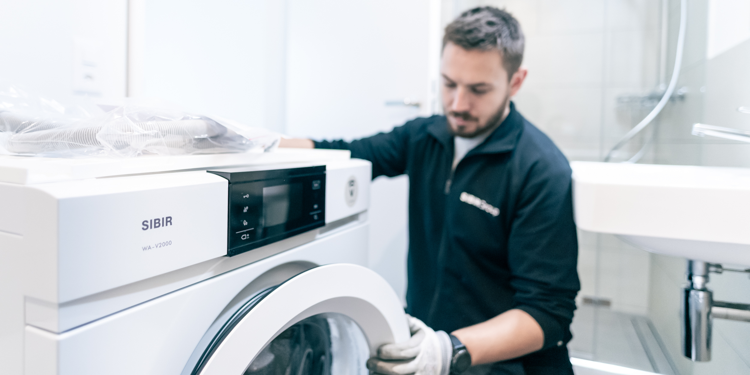 SIBIR service technician repairing washing machine WA-V2000